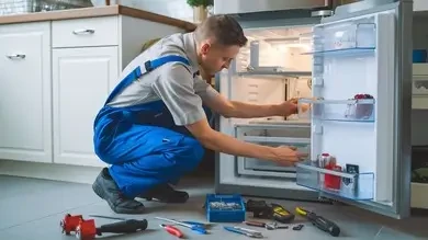 Technician checking the interior of a refrigerator