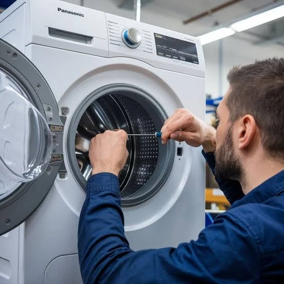 Technician inspecting the door opening and drum of a front-loading washer
